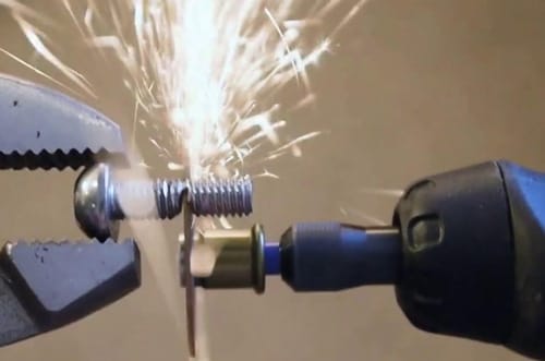 Dremel tool cutting a bolt