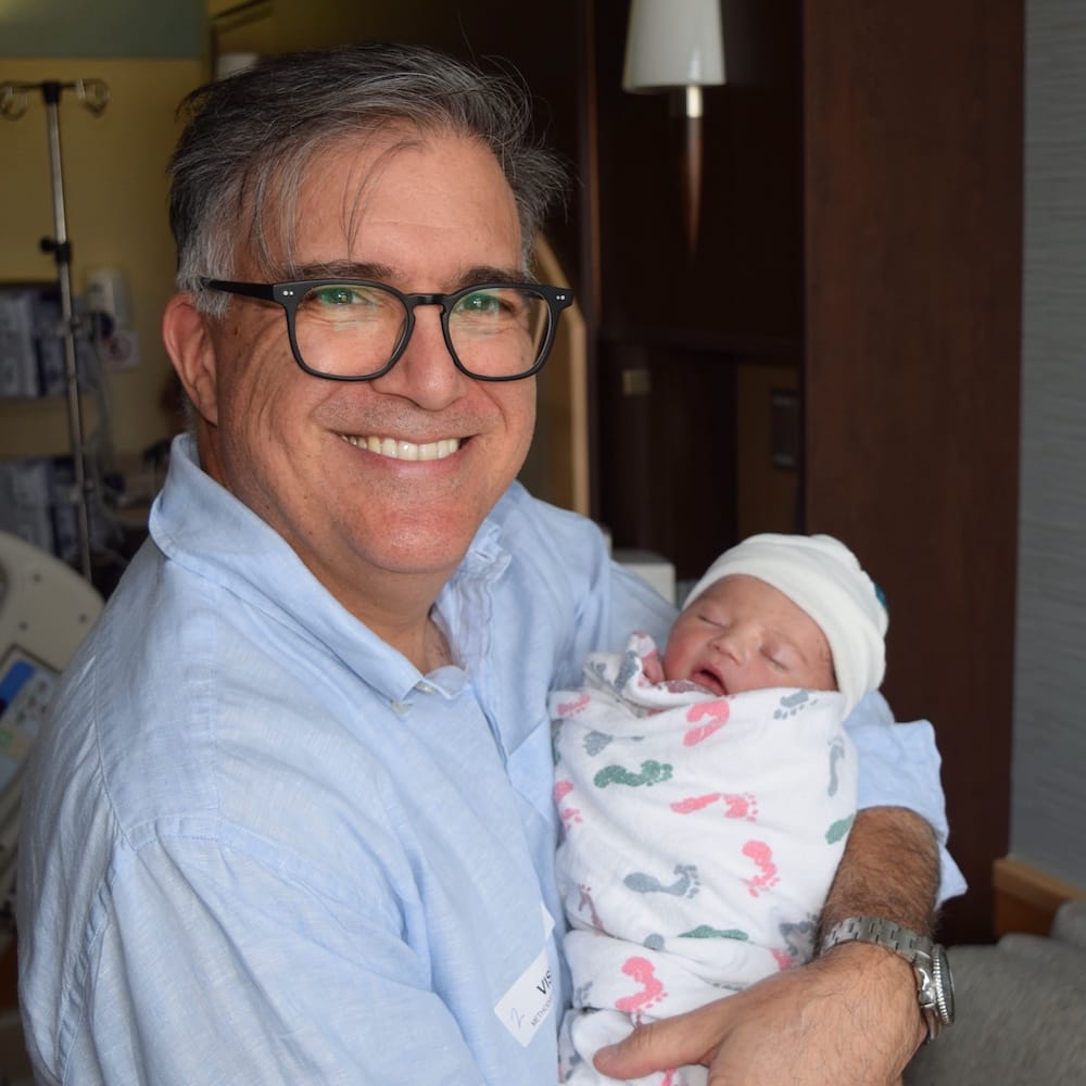 Greg holding his grandson