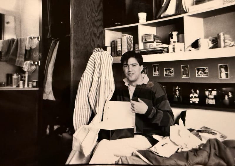 Greg in 1989 in his college dorm opening a present from some admirer