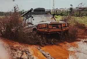 a picture of a truck wallowing in the mud just long enough to not get stuck